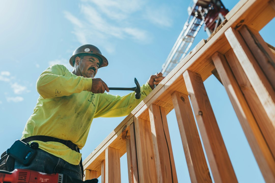Professional contractor in safety equipment working on a home